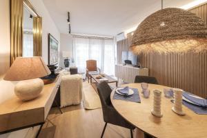 a living room with a dining table and a living room with at The Miks Sur Mer 2 in Roses