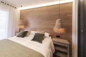 a bedroom with a large bed with two pillows at The Miks Sur Mer 2 in Roses +9 photos