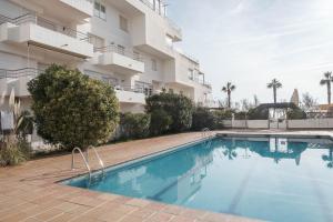 a swimming pool in front of a building at The Miks Sur Mer 2 in Roses