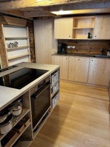 a large kitchen with wooden cabinets and a counter top at Hirschberg 231 in Bizau +25 photos
