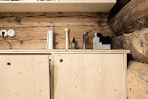 a wooden cabinet with candles and other items on it at Hirschberg 231 in Bizau