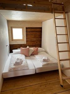 a bedroom with a bunk bed with a ladder at Hirschberg 231 in Bizau