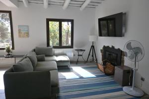 a living room with a couch and a tv at Homenfun Costa Brava Begur Villa in Begur