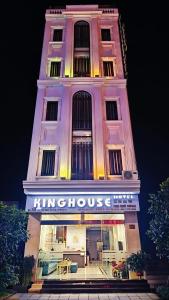 a building with a clock tower with a store at King House Hotel in Móng Cái
