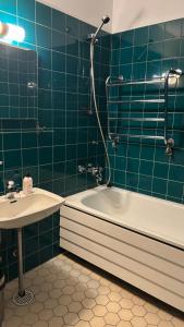 a bathroom with a tub and a sink and a shower at Hotelli Kantakievari in Ruovesi