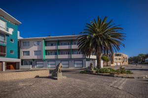 a palm tree in front of a building at Loewenhof Seaview Suites Unit 7 in Swakopmund