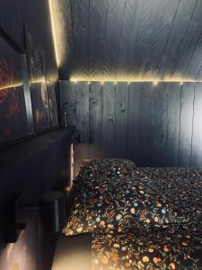 a bedroom with a bed with a blanket on it at Loft Cierp-Gaud in Cierp