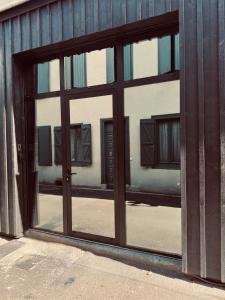 a view of a building through a glass door at Loft Cierp-Gaud in Cierp