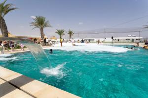 a swimming pool with a fountain in the water at DAR AMMAR in El Jem