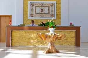 a woman standing behind a counter in a building at DAR AMMAR in El Jem +22 photos