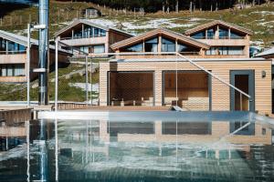 a building with a water fountain in front of it at Torghele's Wald & Fluh in Balderschwang