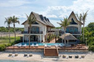 a house on the beach with a swimming pool at Casa Rodi Zanzibar in Jambiani