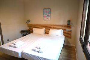 a bedroom with a bed with two towels on it at Homenfun Costa Brava Begur Villa in Begur +34 photos