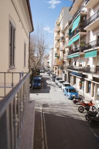 a view of a street with parked cars and buildings at Zia Piera in Follonica