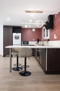 a kitchen with a table with a chair and a microwave at Logement entier avec jacuzzi proche futuroscope in Naintré
