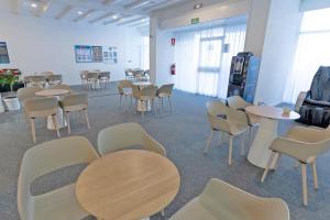 a waiting room with tables and chairs in a building at BLUESEA Interpalace in Puerto de la Cruz