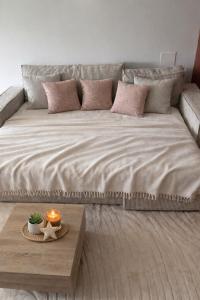a large bed in a room with a table at Logement entier avec jacuzzi proche futuroscope in Naintré +13 photos