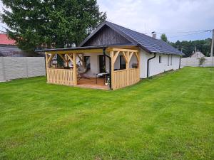 a gazebo with a deck in a yard at Chalupa uprostred niceho in Hlinsko