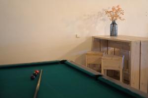 a pool table in a living room with a table at Haus Gänsefarm - Ihre Monteurs Wohnung - in Husby
