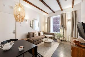 a living room with a couch and a table at Lofts Le Plateau in Montreal