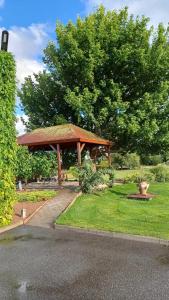 a pavilion in a park with trees and grass at Apartmány Vinařství Tesařík in Prušánky