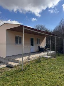 a house with a porch and a patio at Vikendica Luka in Čanj