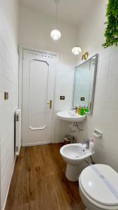 a bathroom with two sinks and a toilet and a mirror at Bellaria Portofino in Rapallo +24 photos
