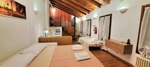a bedroom with a bed with two towels on it at open space apt - comodo a Venezia in Treviso
