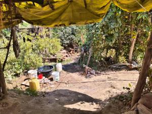 a tent with a fire hydrant in a dirt field at Virendra Home Stay in Kartal