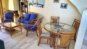 a living room with a glass table and chairs at Pasha Bay Residence in Sounio
