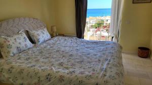 a bedroom with a bed with a view of the ocean at Pasha Bay Residence in Sounio +14 photos