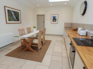 a kitchen with a dining room table and chairs at Cragg Lodge in Hexham