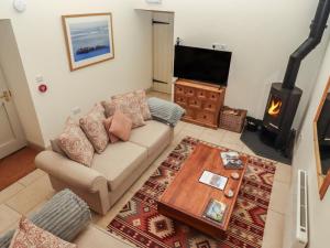 a living room with a couch and a wood stove at Cragg Lodge in Hexham
