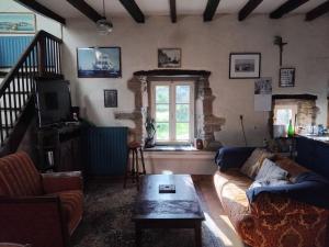 a living room with a couch and a table at Face à la Mer in Perros-Guirec