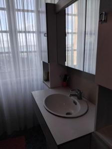 a bathroom with a sink and a mirror and window at Face à la Mer in Perros-Guirec +21 photos