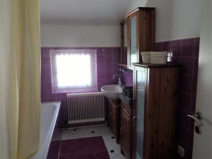 a bathroom with a tub and a sink and a window at Ferienwohnung Piontek in Ebensee +17 photos