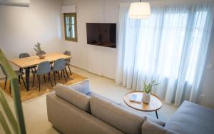 a living room with a couch and a table at Villa Selina 3 - Etheras Properties in Kythira
