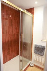a shower with a glass door in a bathroom at Les Écuries - Studio Hyper Centre & Bouffay in Nantes