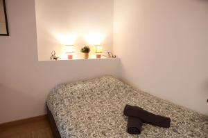 a bedroom with a bed with a shoe on it at Les Écuries - Studio Hyper Centre & Bouffay in Nantes +4 photos