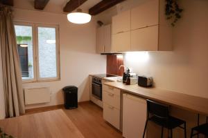 a kitchen with white cabinets and a counter top at Les Écuries - Studio Hyper Centre & Bouffay in Nantes