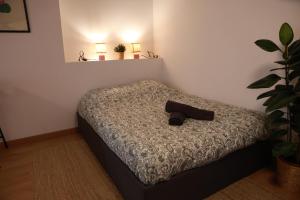 a bedroom with a bed with a shoe on it at Les Écuries - Studio Hyper Centre & Bouffay in Nantes