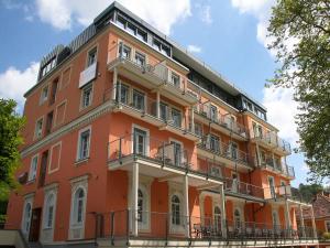a orange building with balconies on the side of it at Hotel Grazerhof in Bad Gleichenberg