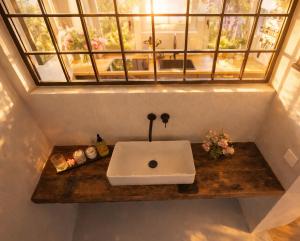 a bathroom sink on a wooden counter with a window at Boutique Loft Studio in Kreuzlingen