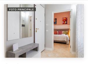 a bathroom with a sink and a mirror and a bedroom at Appartamento la Speranza in Grosseto