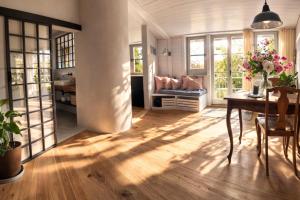a living room with a table and some windows at Boutique Loft Studio in Kreuzlingen