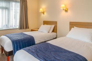 a hotel room with two beds and a window at Carrington House Hotel in Bournemouth