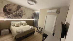a bedroom with a bed and a painting on the wall at Affittacamere Nonna Maria in Foggia