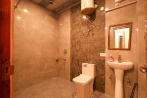 a bathroom with a toilet and a sink at The Himvan Stay in Mundaghat 