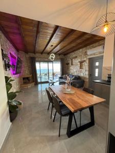 a kitchen and dining room with a wooden table and chairs at Drios Hillhouse II in Drios