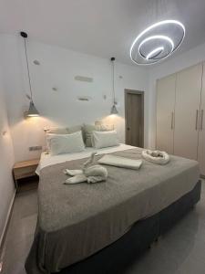a bedroom with a large bed with towels on it at Drios Hillhouse II in Drios +28 photos